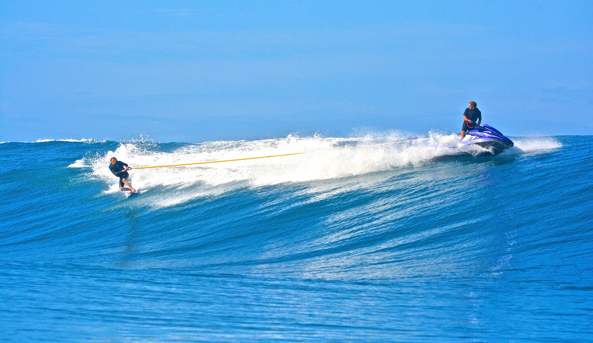 Laurie Towner getting towed in by Laird Hamilton. Photo: Kenna Colburn