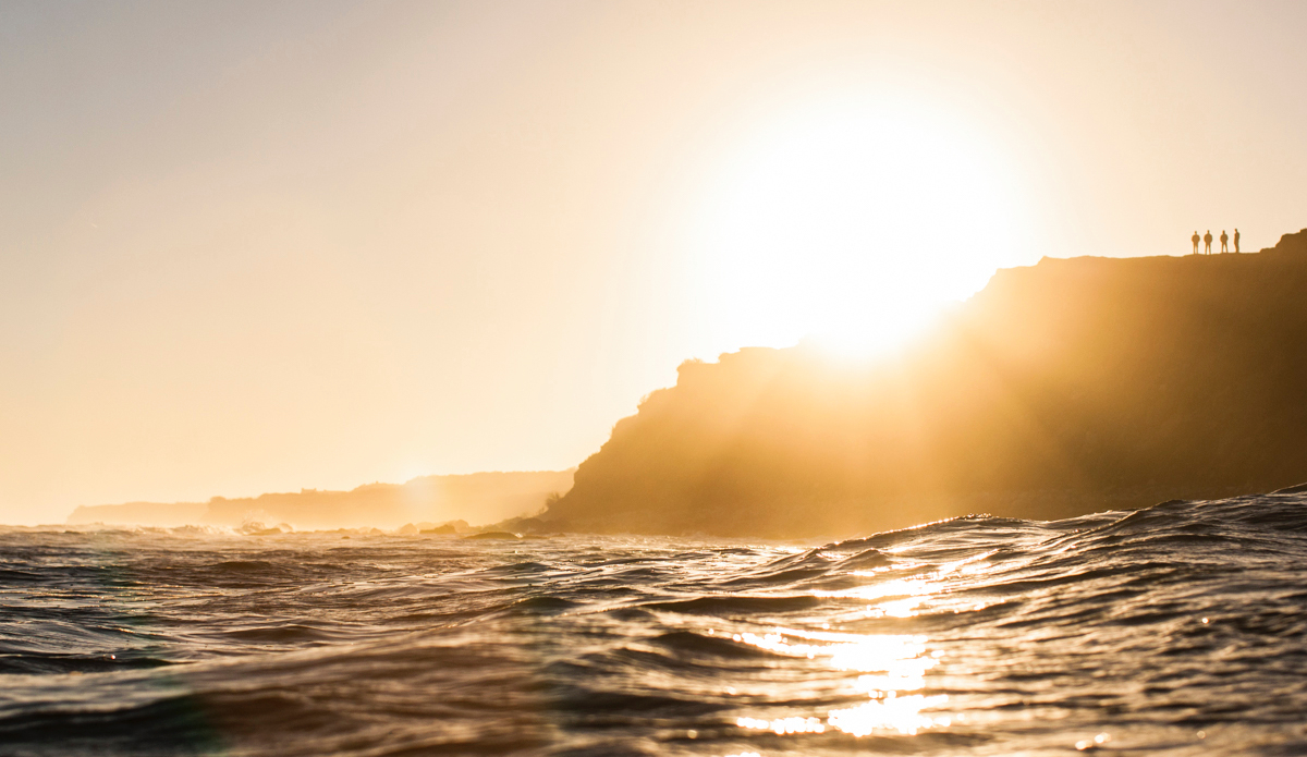 One of my favorite views from home. Pictured are the \"jetty grinders\" checking the waves in the distance. 