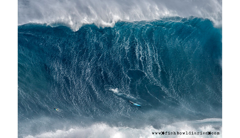 That\'s Shane Dorian\'s board and outline in the wave, while Pete Mel looks on from an uncomfortable spot.  Photo: <a href=\"https://fishbowldiaries.com\">Sofie Louca - Fish Bowl Diaries</a> 