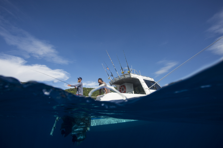 A promising underwater drop-off reveals no fish, and I spend much of the time in the water working to get the right perspective on the boat with the small island behind. 