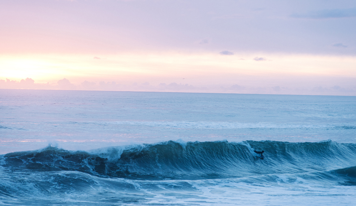 Some bodyboarder breaking glass as the sky sets into a cotton candy palette of colors. Photo: <a href=\"https://www.lookdontspeak.com\">Andrew Simoni</a>