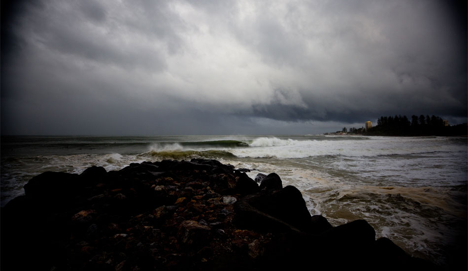 TRANSITION - KIRRA, AUSTRALIA. With Snapper in the background and a low lying storm moving in, this wave traveled along the points until it rolled into Kirra and some lucky guy got into the pocket. Photo: <a href=\"https://www.bluespherephotography.com\">Shelli Bankier</a> 