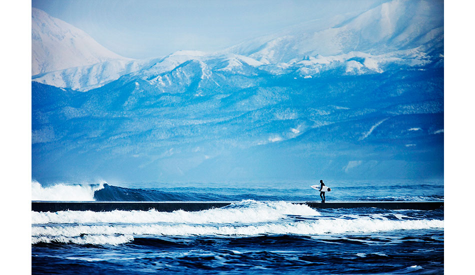 Dan Malloy walking down a jetty straight into the lineup in Japan. Photo: <a href=\"https://www.briannevins.com/\" target=_blank>Brian Nevins</a>