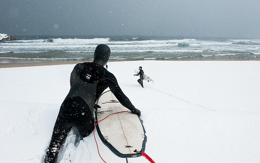 Korean surfers, Moonjun Bae and Young-ik Son, clamber over huge snowdrifts to get out there for a couple of chilly peaks. Photo: <a href=\"https://www.shannonaston.com/\" target=_blank>Shannon Aston</a>.