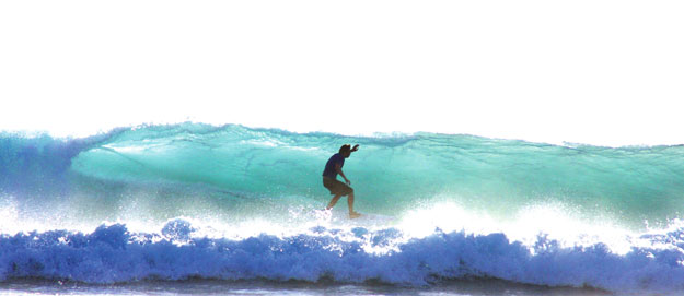 GaySurfers.net Founder Chris C surfing a perfect wave in Indonesia