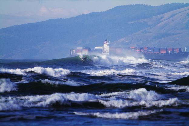 A tanker ship passes by a surfer at Ocean Beach.  Photo: Seth Migdail/SFGate.com