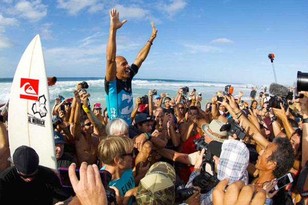 King Kelly gets chaired up the beach for lucky number seven at Pipe. Photo: Matt Dunbar