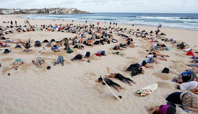 Many believe that Tony Abbott has his head in the sand when it comes to climate change. Photo:  Mic.com