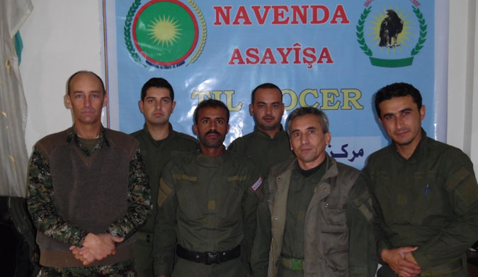 Parker, left, pictured with the Kurdish forces. Photo: Facebook