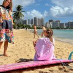 women wearing surf ponchos at the beach