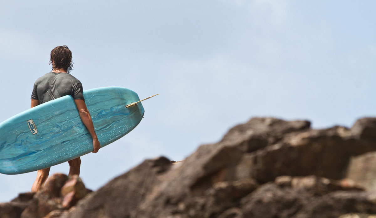 January: Unknown surfer, homeward bound at Noosa Point. Photo:<a href=\"https://www.narrowpathmedia.com.au/#0\"> Andrew Carruthers</a>