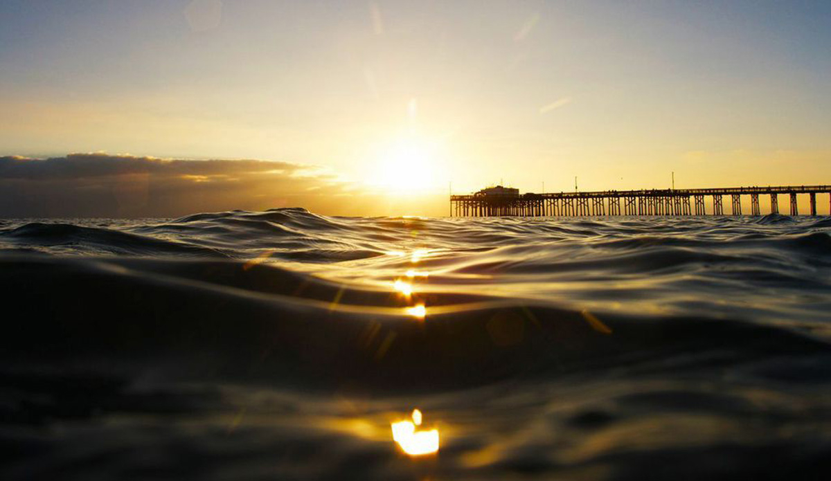 Serenity. Even when the waves aren\'t on, it\'s the best feeling to be in the ocean and watch the sunset from the water. Photo: <a href=\"https://www.etsy.com/shop/AaronBrucePhoto\">Aaron Bruce</a>