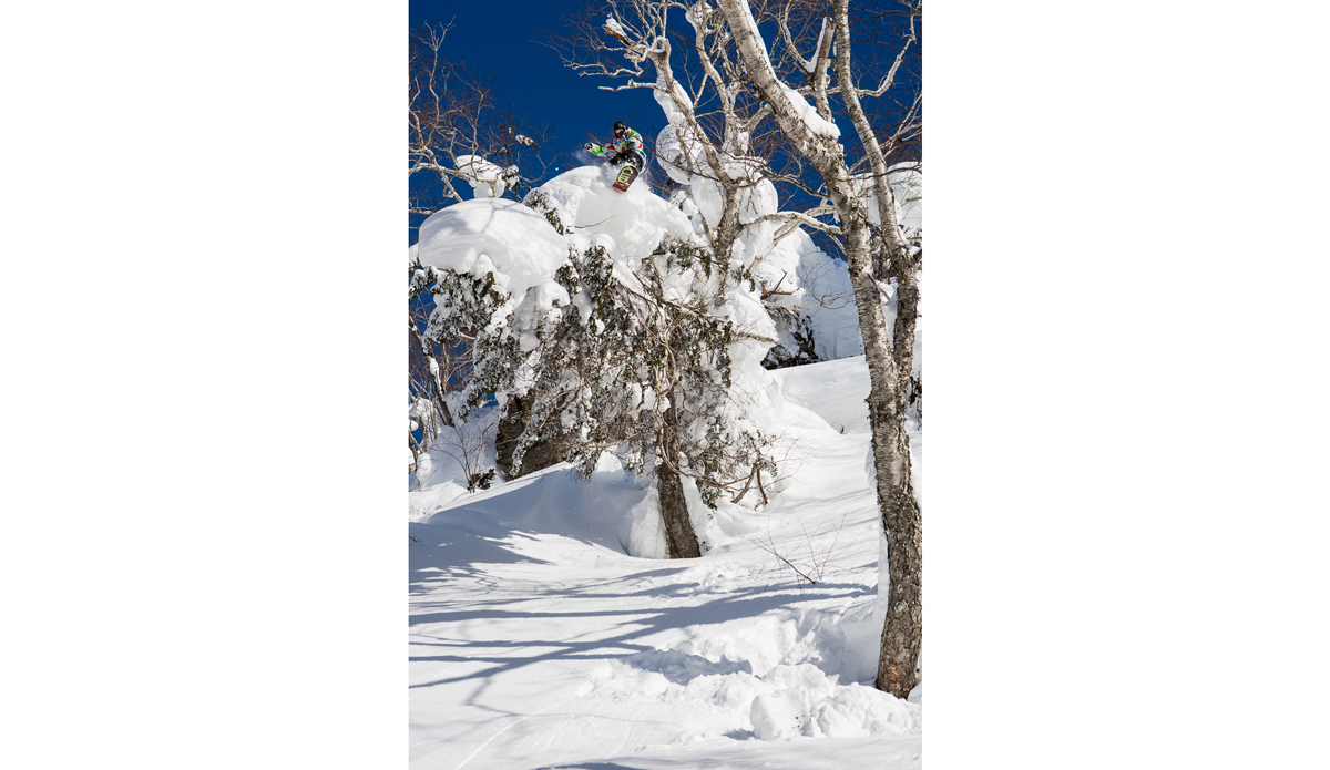 Heikki Sorsa with a large tree ride to drop.  Getting good snow in Hokkaido Japan isn’t usually the issue, but having sun and snow is rare.  We got really lucky this trip and were able to get shots like this. Photo: <a href=\"https://www.adammoran.com/\">Adam Moran</a>