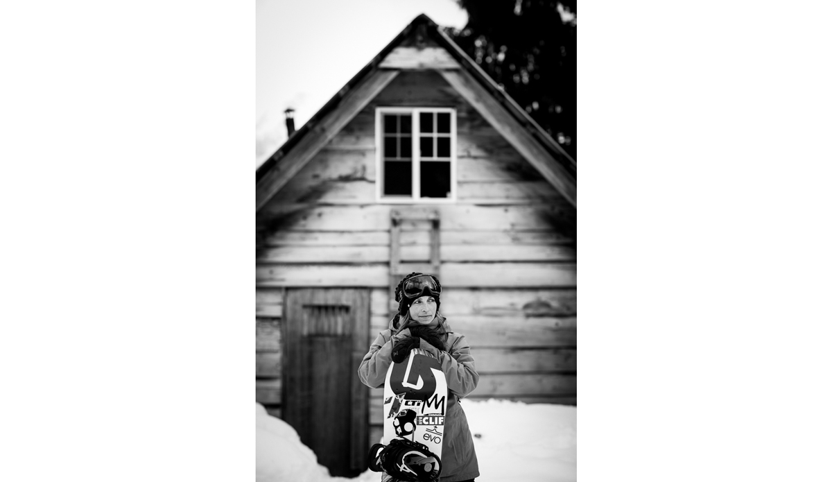 Kimmy Fasani in her element by a cabin in the backcountry. Kimmy has come a long way from riding parks to keeping up with men on her snowmobile and continues to push what women do in the backcountry. Photo: <a href=\"https://www.adammoran.com/\">Adam Moran</a>