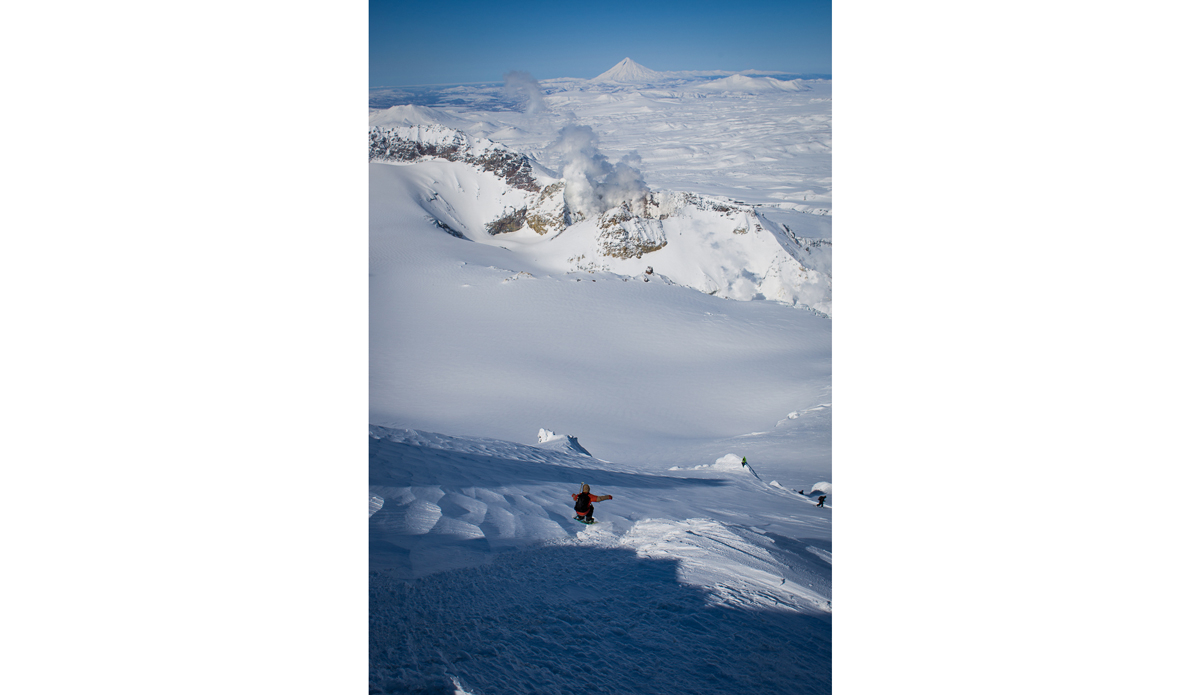 Sani Alibabic dropping into sold ice wind crust in the crater of a volcano in Kamchatka Russia.  We were dropped off on the top of the crater and able to ride right down to the smoking bubbling lava at the very bottom.  That’s an experience I don’t know if ill ever get to repeat. Photo: <a href=\"https://www.adammoran.com/\">Adam Moran</a>