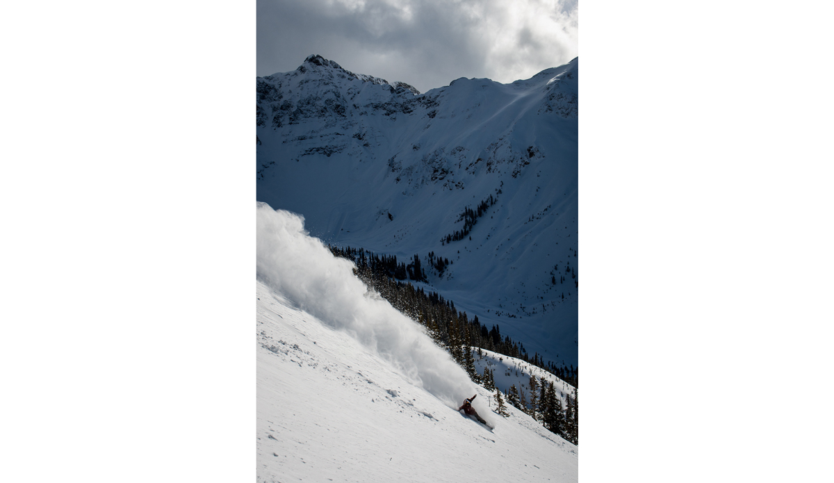 Everyone saw all the shots of Shaun learning double corks in a private halfpipe at Silverton Mountain.  Those days at that pipe were the fast forward button on snowboard progression.  David Benedek had done doubles years before but not many riders felt the need to try to catch up.  Once the Olympics madness started and Shaun put these tricks into his runs, the rest of the guys were catching up as fast as they could.   What NBC didn’t snow from Silverton were the pow runs Shaun got when the pipe would fill in with snow. If you look in the background of this shot you can see the halfpipe and a snowcat digging it out after the storm. Photo: <a href=\"https://www.adammoran.com/\">Adam Moran</a>
