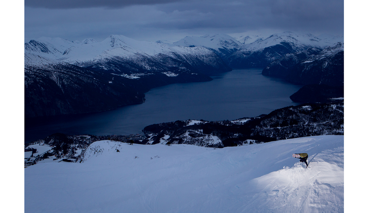 We landed in Oslo, drove through the night in rain storm, and woke up the next day in Stranda at about 1 in the afternoon.  We decided to go check out the resort for a few runs and warm up for our upcoming heli trip.  At the very last moment I decided to bring my camera since they told us the lift was shutting down soon.  We ended up shooting this handplant on our one run down, then it started raining again and never stopped.  The heli trip got cancelled and had I not brought my camera up on this run I would’ve come home from Norway with zero photos.  Instead I got one. Photo: <a href=\"https://www.adammoran.com/\">Adam Moran</a>