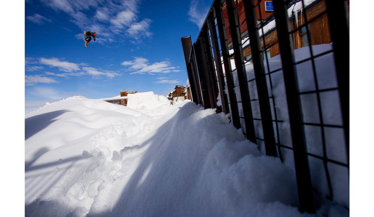 In the summer of 2005 we had a catalog shoot going on in Valle Nevado Chile and the resort was hit by one of the biggest storms they ve ever gotten.  It snowed for days and when the sun finally came out the lifts were buried and it was going to take them a day or so to dig them out.  With sun and new snow we decided to turn the resort into our own park and shoot on the hills beside the hotel.  Trevor Andrew was always down to get shots and here he is with a cab 5 after a snowmobile tow in through the parking lot. Photo: <a href=\"https://www.adammoran.com/\">Adam Moran</a>