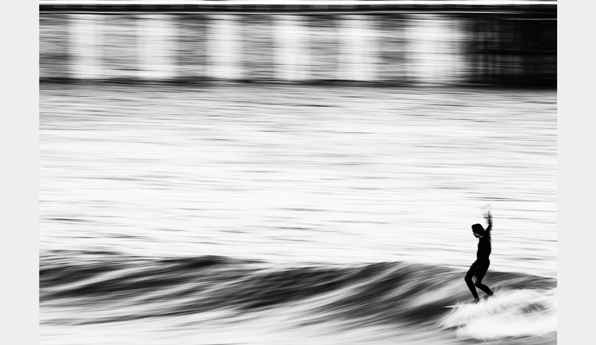 Sharpness alone won’t really create a memorable image. I wanted to get a higher angle to show more of the water and less horizon. Style was added by the unknown rider cruising down the line.  Photo: <a href=\"https://www.facebook.com/chrisdelorenzophotography\">Chris DeLorenzo</a>