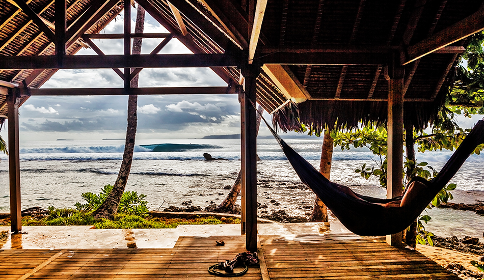 This was taken in the Mentawais. It was my first time there and I swear it\\\'s just so overwhelming as a photographer. After about five days on the boat I took the opportunity at E-bay to shoot from land. Of course I didn\\\'t expect the torential downpour that led to me seeking cover in this hut with some Europeans, one of which was setting up his hammock. I remember this quite clearly, it really was a great moment. Photo: <a href=\"https://clarkography.com/\" target=_blank>Matt Clark.</a>