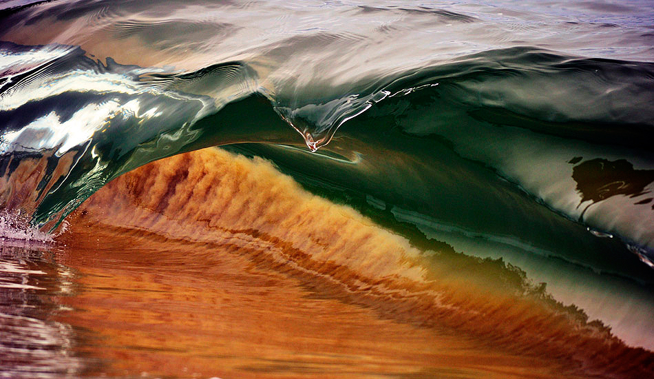 I laid low for this one in an endeavor to capture the sand being sucked up, the colors and the girth of the lip. Photo: <a href=\"https://www.debmwaveart.webs.com/\" target=_blank>Deb Morris</a>.