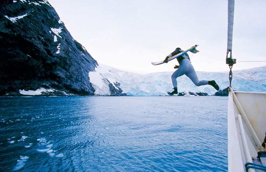 2000. Chris Malloy. Jumping off the boat in Antarctica. Photo: <a href=\"https://www.artbrewer.com\" target=_blank>Art Brewer</a>