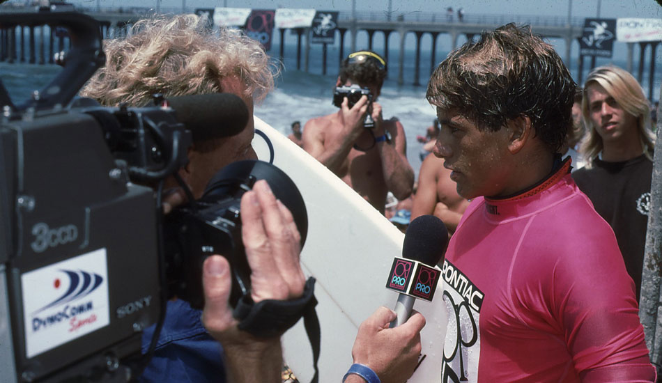 A young Kelly Slater takes a post-heat interview at the OP Pro. Photo <a href=\"https://www.aspworldtour.com\">courtesy of the ASP</a>