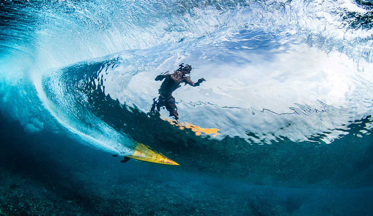 Local lad Basi cutting through some Mentawai glass. Photo: <a href=\"https://johnbarton.net.au/\">John Barton</a>