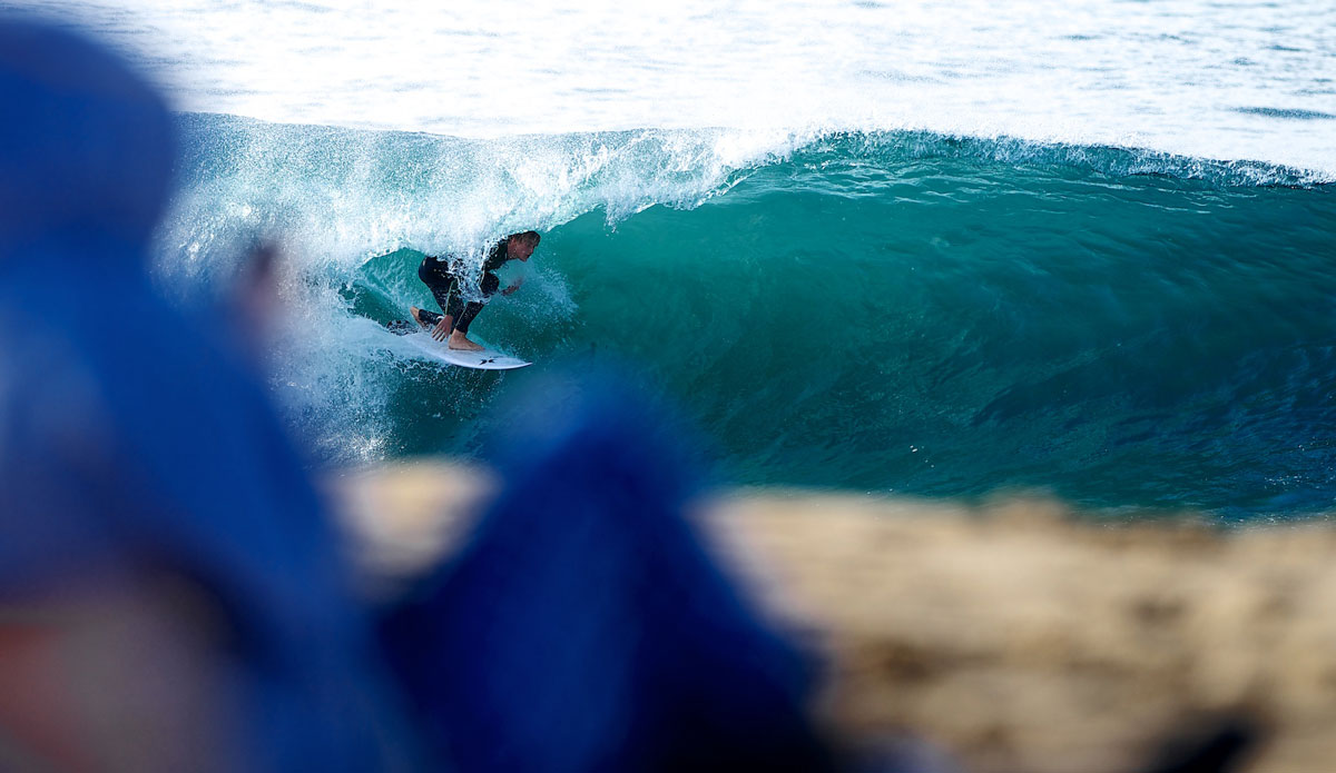Newport local Preston Dexter drags a hand to stall and stay deep in front of the morning crowds at The Wedge. Photo: <a href=\"https://www.driftwoodfoto.com/\">Benjamin Ginsberg</a>