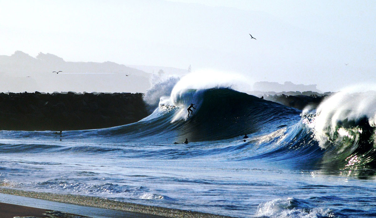 To me, this photo of Morgan Craig dropping a steep, sunlit, early morning peak tells a perfect story of the illusion that is surfing at Wedge. Photo: <a href=\"https://www.driftwoodfoto.com/\">Benjamin Ginsberg</a>