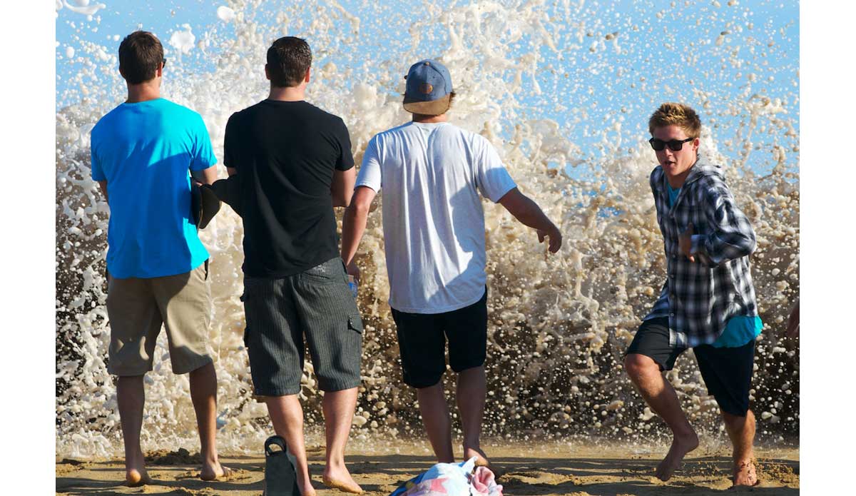 Watching tourists get drenched when a massive wall of whitewater zips up the beach and crests the steep bank is nearly as entertaining as watching the action in the water. Photo: <a href=\"https://www.driftwoodfoto.com/\">Benjamin Ginsberg</a>