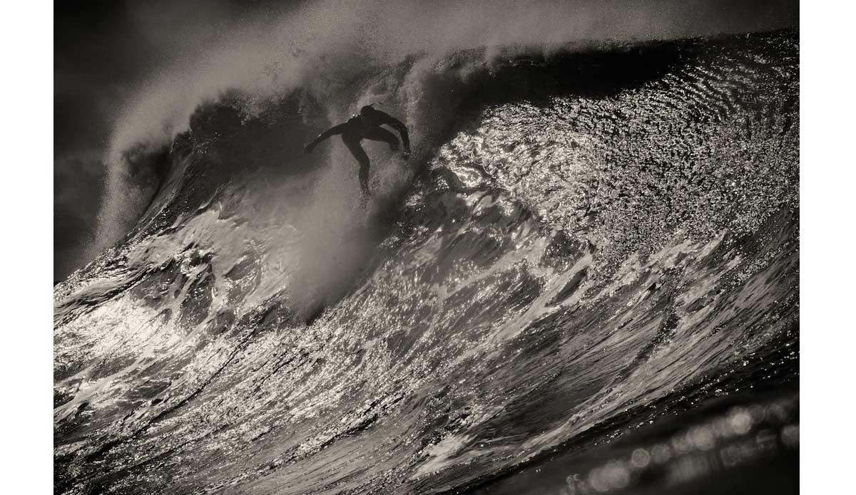 Dropping at the Wedge is never a smooth ride. You can see the refracting wave\'s path in the surface texture as it moves up the face of this peak Morgan Craig is dropping. Photo: <a href=\"https://www.driftwoodfoto.com/\">Benjamin Ginsberg</a>