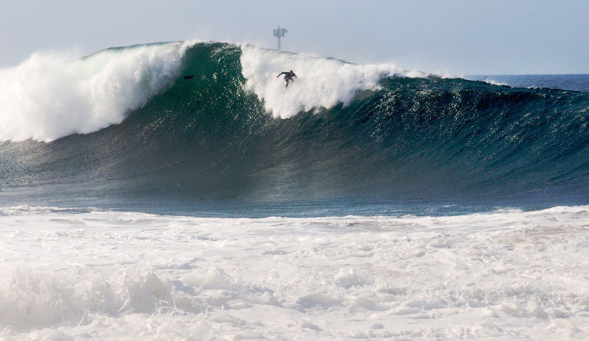 Things move fast at the Wedge. This wave peaked and broke before Spencer Pirdy could fully stand- and it\'s still this massive as he charges down the face. Photo: <a href=\"https://www.driftwoodfoto.com/\">Benjamin Ginsberg</a>