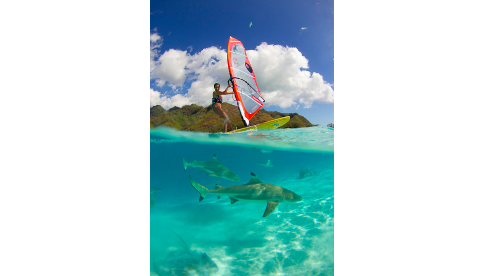 Carine Camboulives windsurfing over the sharks in Moorea, French Polynesia. Photo: <a href=\"https://benthouard.com/\" target=_blank>Ben Thouard</a>.
