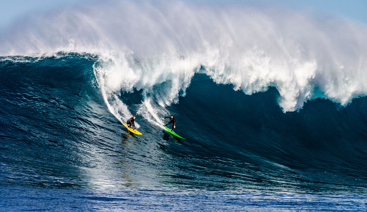 Elias Btesh (green board) and Sage Burke (yellow board) share a good one. Photo: <a href=\"https://www.driftwoodfoto.com/\">Ben Ginsberg</a>