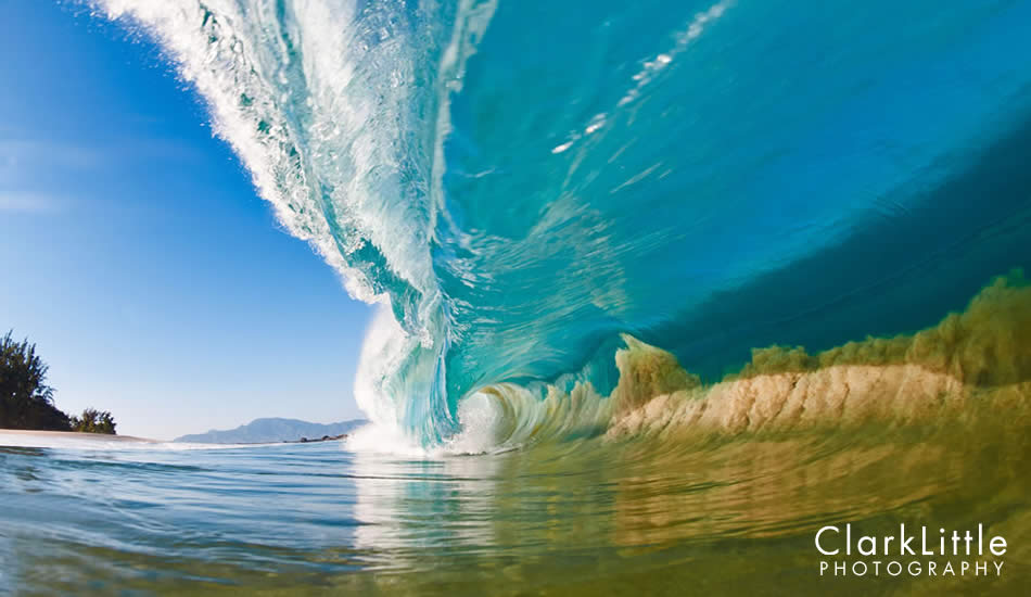 A large North Shore wave makes its way into a shallow sand bank, sucking the sand off of the sea floor into the wave itself. Photo: <a href=\"https://ClarkLittlePhotography.com\" target=\"_blank\">Clark Little</a>.