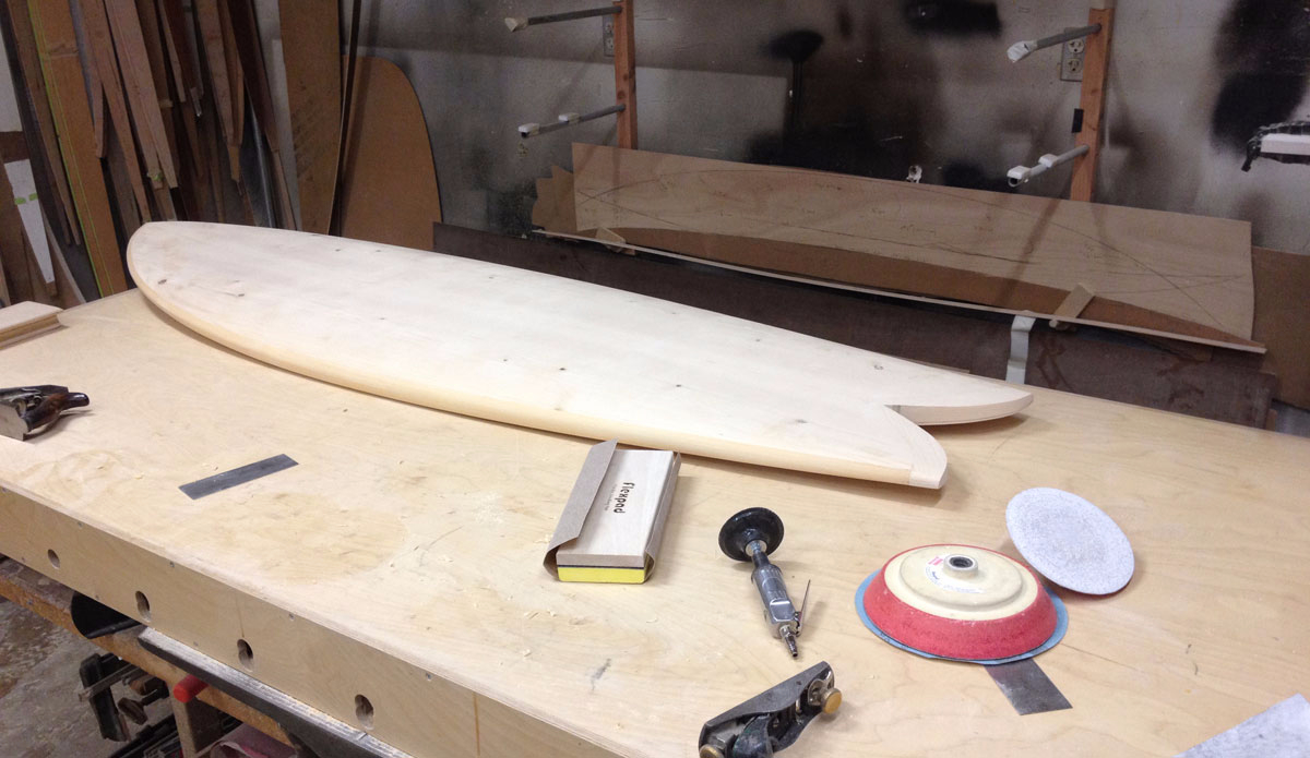 \"\"The deck is just shy of 1/8\" and the bottom just shy of 1/16\". These were vacuum bagged onto the blank with a layer of glass and epoxy between the skins and foam. I then cut a little more than 3/8\" from the perimeter of the board and laminate the rails on.\"