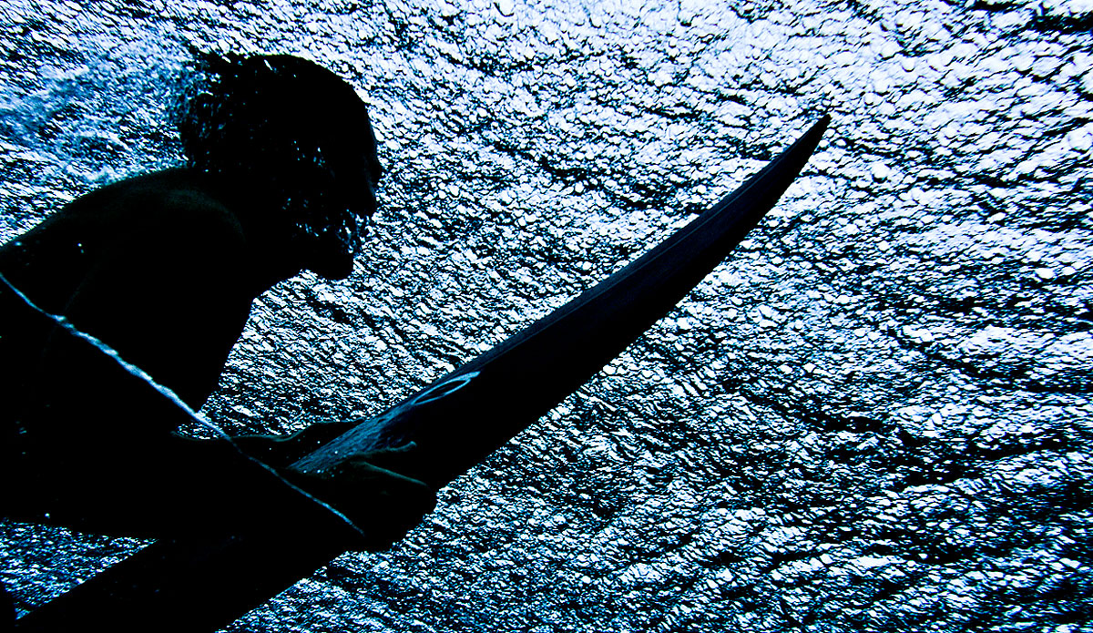 Duckdive.  No matter who you are or how good you are, there\'s always a set that swings wide and gets ya.  This day was a about 10\' (faces).  I was shooting with a 50 mm lens and Gavin was paddling back out towards me when this set wave swept through.  This being the first of a few.  Luckily we nailed this shot before it got too foamy and mixed up.  Photo: <a href=\"https://www.bobridges.com/\">Bo Bridges</a>