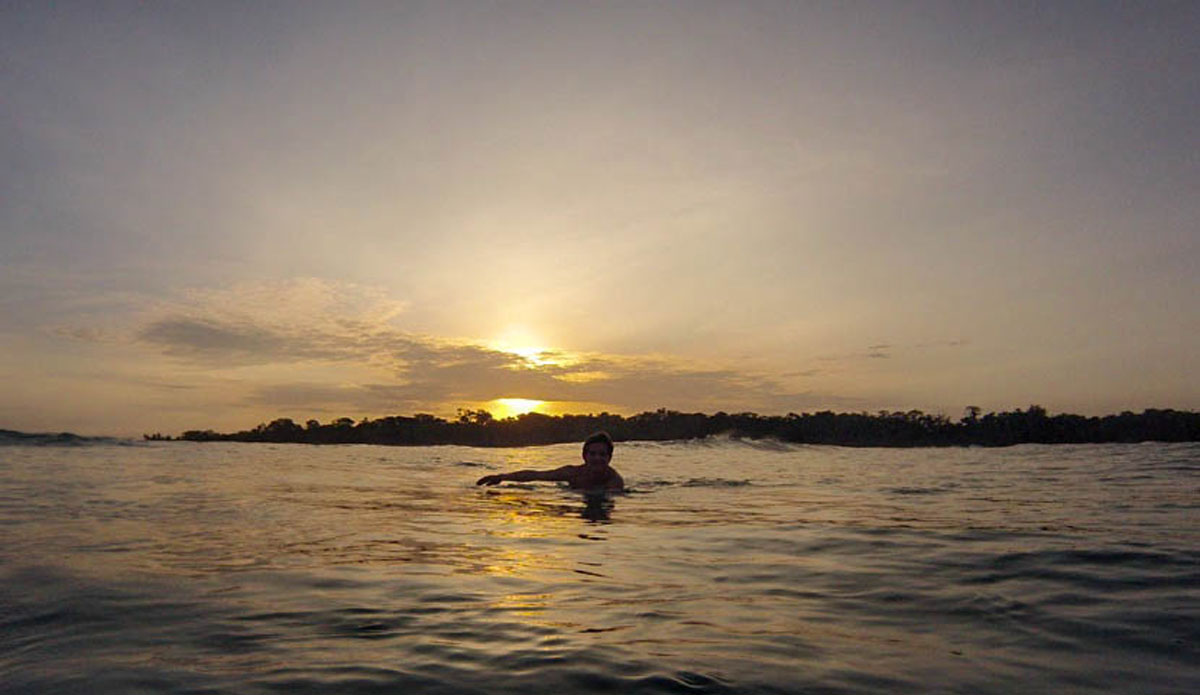Tyler Correll (@tylerwcorrell) probably smiling while paddling back to the boat at the end of an epic sunset session. Photo: <a href=\"https://www.facebook.com/ColinRothPhoto\"> Colin Roth</a>