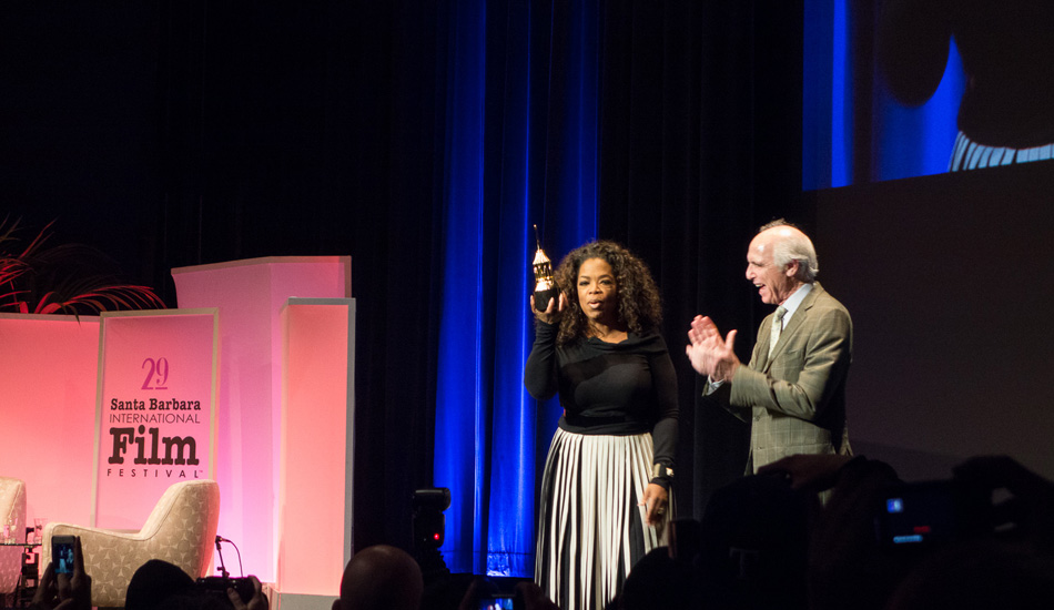 Oprah received the Montecito Award, which was created in recognition of a performer who has given a series of classic and standout performances throughout her career. When asked on the red carpet what her childhood birthday parties were like, she snapped with a kind smile, “We never had any parties, we were too poor to have anything like that.” Oprah’s mom and grandmother were both maids their entire lives and her great grandmother was a slave. Filming for \"The Color Purple\" changed her life, it helped her release herself to grace and it created the inspiration to start her Oprah show to uplift people to see the light inside themselves. Photo: <a href=\"https://lowtiderising.com/\" target=_blank>Branden Aroyan/lowtiderising.com</a>