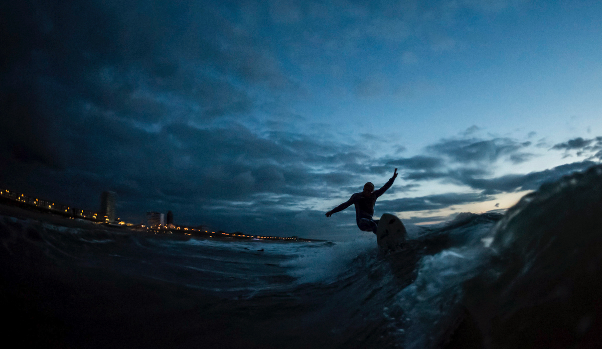 Nightfall top turn. Martijn van Hoek at The Spot in Zandvoort, Netherlands. Photo: <a href=\"https://www.thesurfoffice.com/blog/2014/11/27/brendan-it-director-surf-photographer\"> Brendan Bank</a>