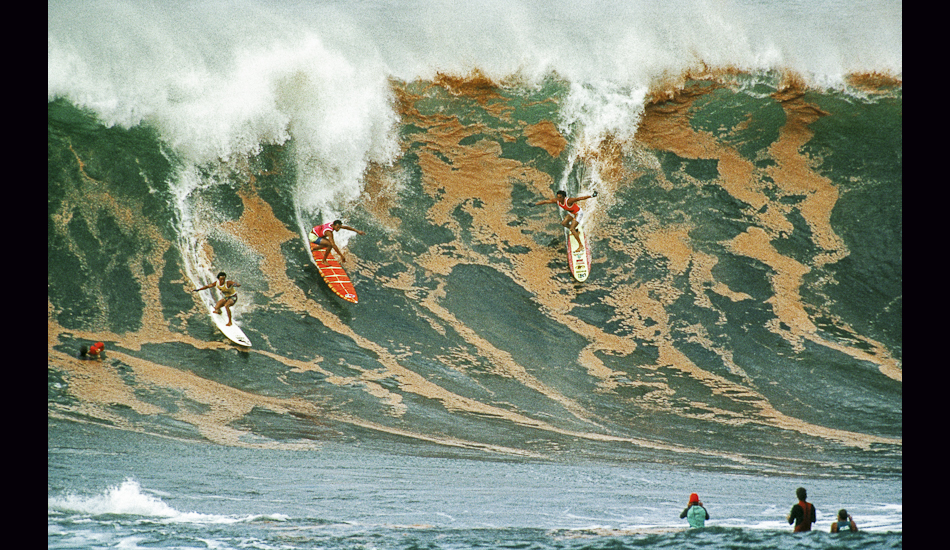 Dennis Pang, Marvin Foster, and Mark Foo, Red Water, Waimea Bay, Hawaii, 1988. Image: <a href=\"https://www.artbrewer.com/\" target=\"_blank\">Brewer</a>
