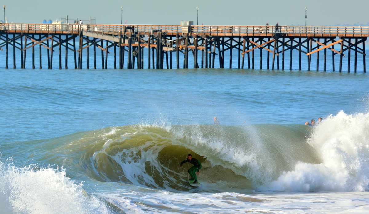 Tony Morelli in green wetsuit pants in a green dirty wave. Photo: Wes Harding