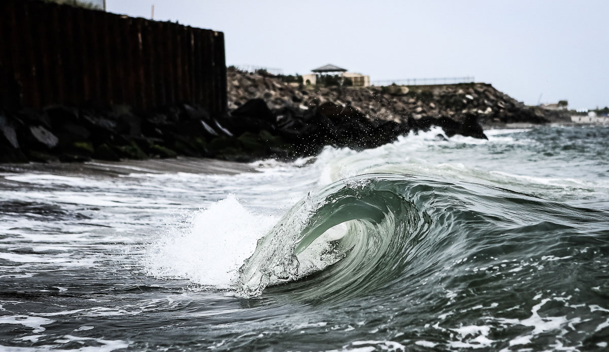 I don’t own a water housing, so attempting shots like this require a strange dance. One of the best breaks around NJ…that barrel tops out at three inches and spits every so often. Photo: <a href=\"https://www.chrisdelorenzophoto.com/\"> Chris DeLorenzo</a>