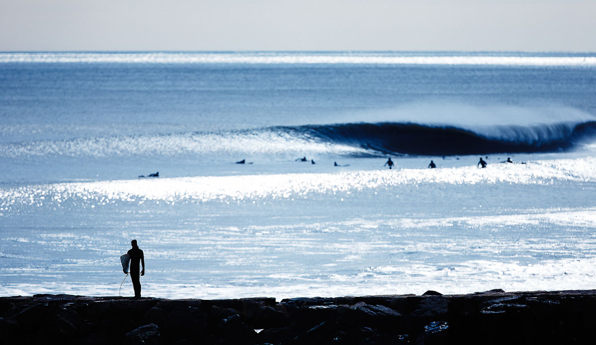 This picture defines my eye. Instinctually I focused on the surfer walking on the jetty. Sometimes I am just way more interested in the human element than the wave. Photo: <a href=\"https://www.chrisdelorenzophoto.com/\"> Chris DeLorenzo</a>