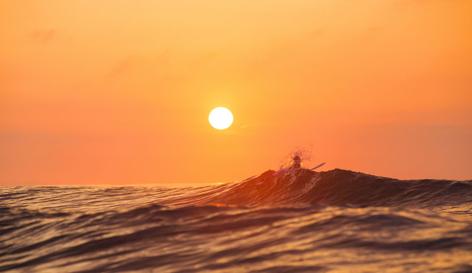 Greeting the sun with a surf. Photo: <a href=\"https://www.chrisfrickphotography.com/\" target=_blank>Chris Frick</a>