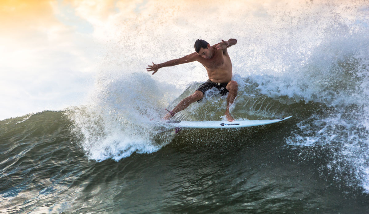 Benny catching a free surf at home in between flights. Photo: <a href=\"https://www.chrisfrickphotography.com/\">Chris Frick</a>
