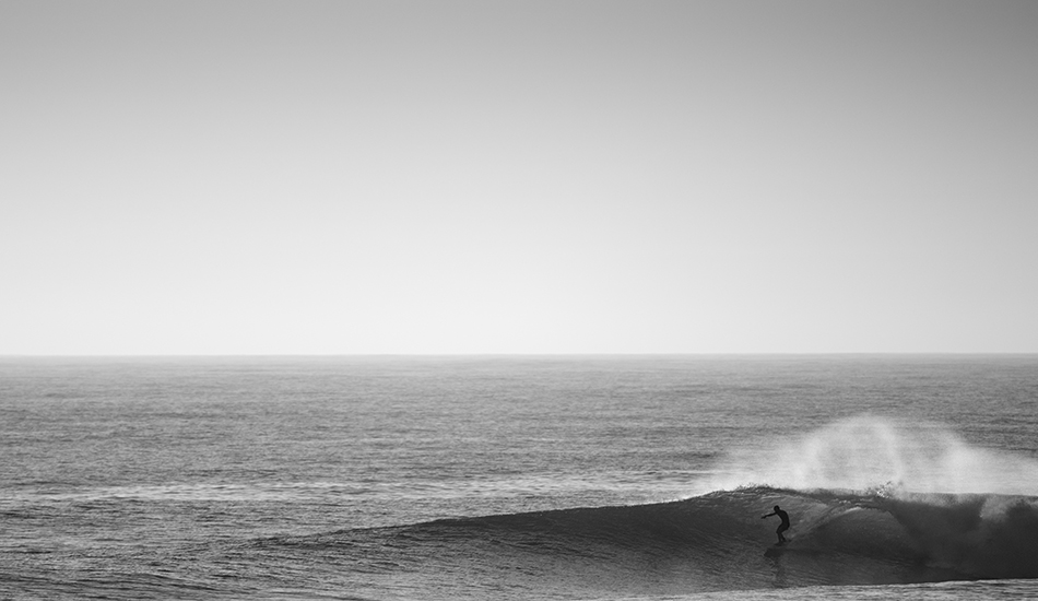 Silhouette. A silhouette parks himself in a nice one out at Shark Island during a summer swell. Photo: Chris Grundy