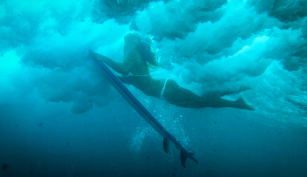 The female form is especially beautiful when duck diving a wave as seen from beneath. Photo: Chrissy Swain