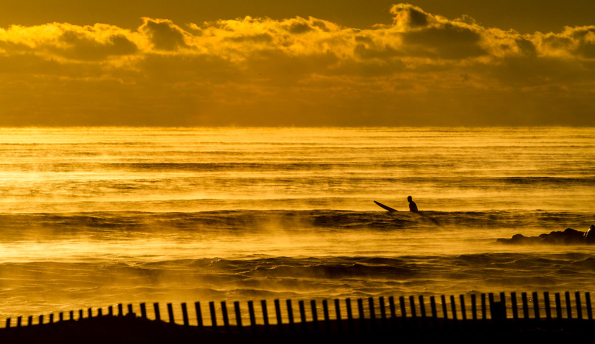An unknown long boarder braving the sub zero temperatures to get an empty lineup. Photo: <a href=\"https://www.christorphotography.com/\">Christor Lukasiewicz</a>